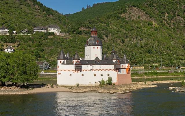 Pfalzgrafenstein Castle, white with red trim and a tall tower, on its island in the Rhine