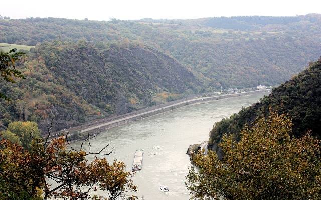 The Rhine flowing between steep wooded slopes in autumn, seen from the Loreley